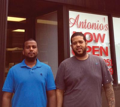Cousins Brian Chavez and Hilson Guerrero outside the newly opened Antonio’s Pizzeria in Fields Corner. Charlie Dorf photo